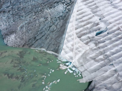 UV-resistant material covers a portion of the Rhône Glacier in order to slow its melting next to a lake created by the glacier's meltwater, on August 19, 2019, near Obergoms, Switzerland.