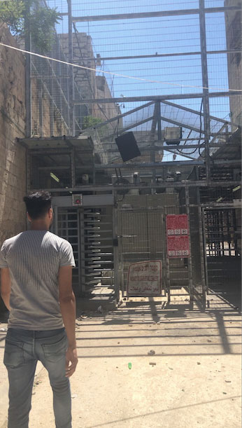 Palestinian man passes through a checkpoint in Hebron.