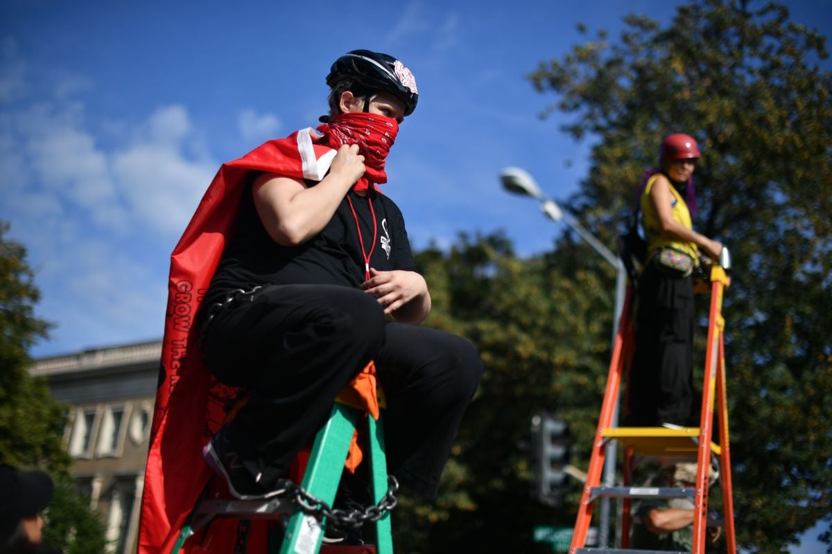 Activists chained to ladders take part in a blockade