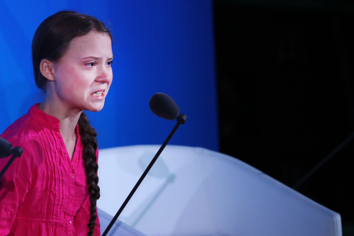 Greta Thunberg speaks into a microphone
