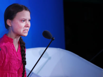 Greta Thunberg speaks into a microphone