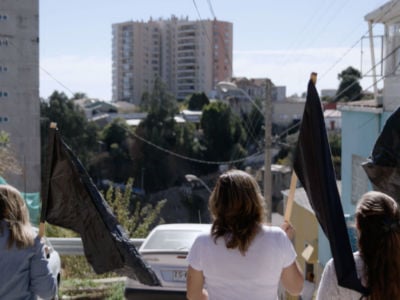 Housing activists carry black flags in Valparaíso, Chile.
