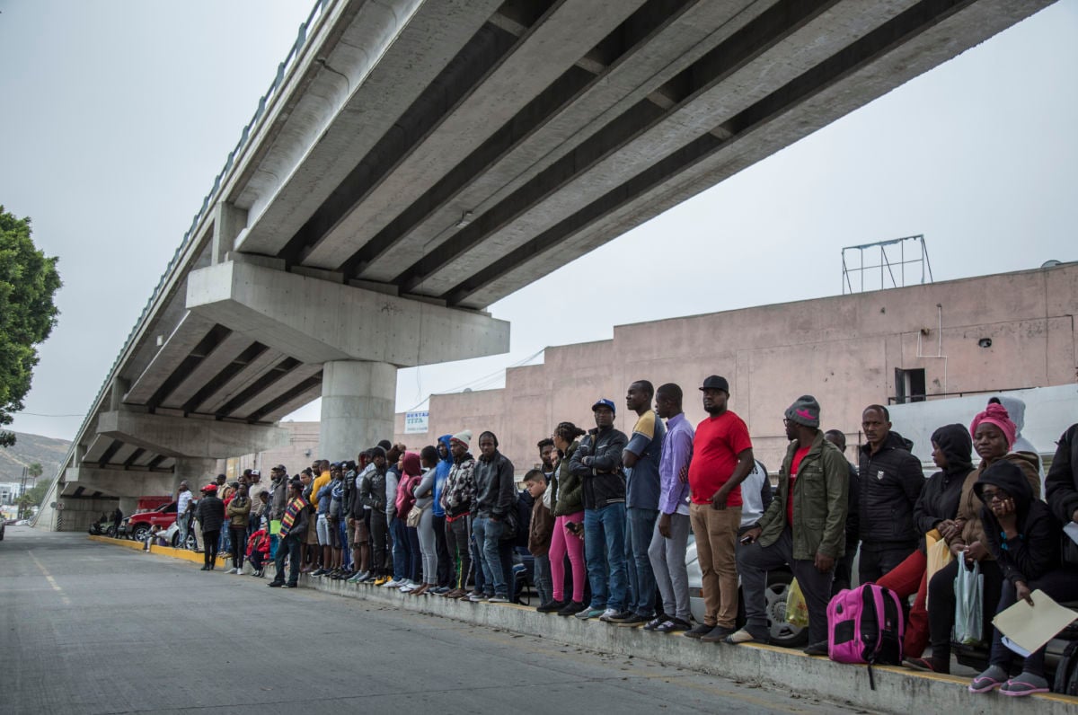 Numerous migrants from Central America queue up at a border crossing between Tijuana, Mexico, and the U.S.