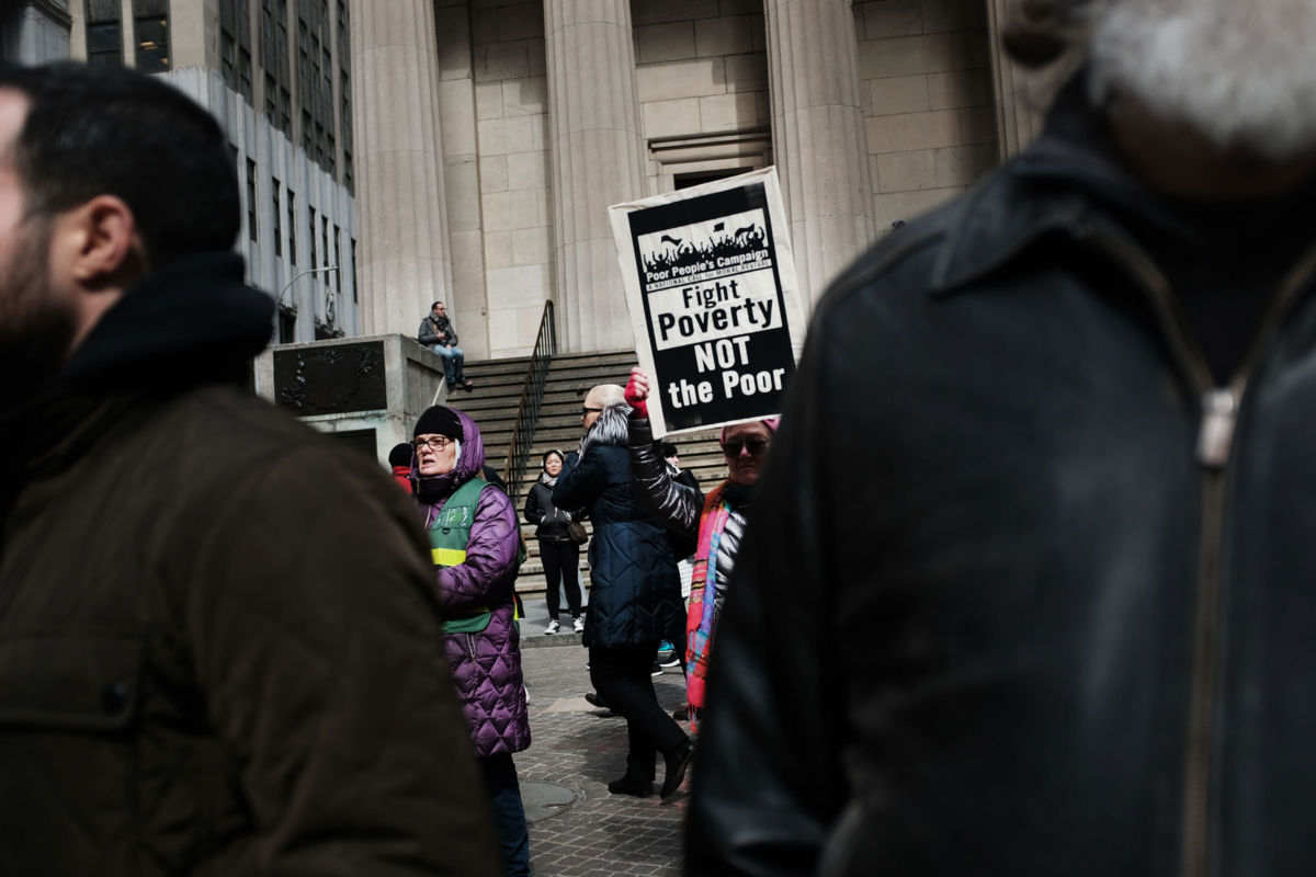 People participate in a march for the Poor People's Campaign in the Financial District on March 18, 2019, in New York City.