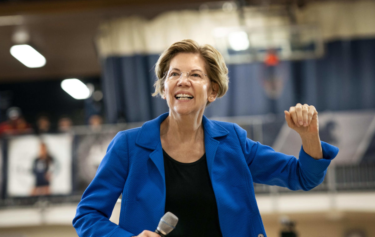 Sen. Elizabeth Warren smiles as she takes the stage during a campaign rally