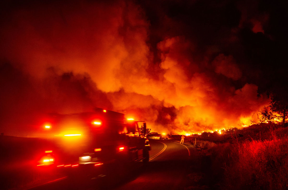 A fire truck heads towards flames during the Kincade fire near Geyserville, California, on October 24, 2019.