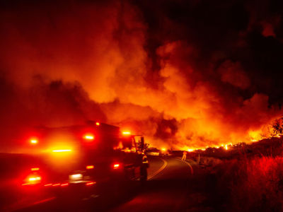A fire truck heads towards flames during the Kincade fire near Geyserville, California, on October 24, 2019.