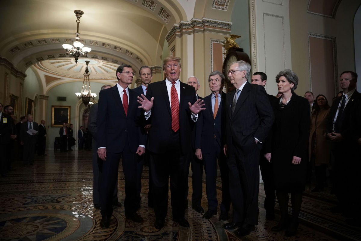 A group of Republican senators and Vice President Mike Pence listen as President Trump speaks to the media at the U.S. Capitol on January 9, 2019.