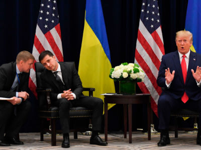 President Trump speaks as Ukrainian President Volodymyr Zelensky speaks with an aide during a meeting in New York on September 25, 2019, on the sidelines of the United Nations General Assembly.