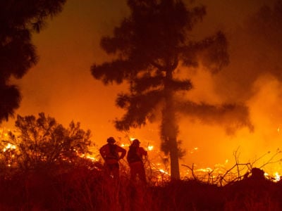 Firefighters battle a raging wildfire