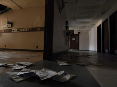 Billing envelopes litter the floor of the shuttered Southeast Health Center in Ellington, Missouri on July 19, 2019. The rural hospital closed in March of 2016 and was $17 million in debt.