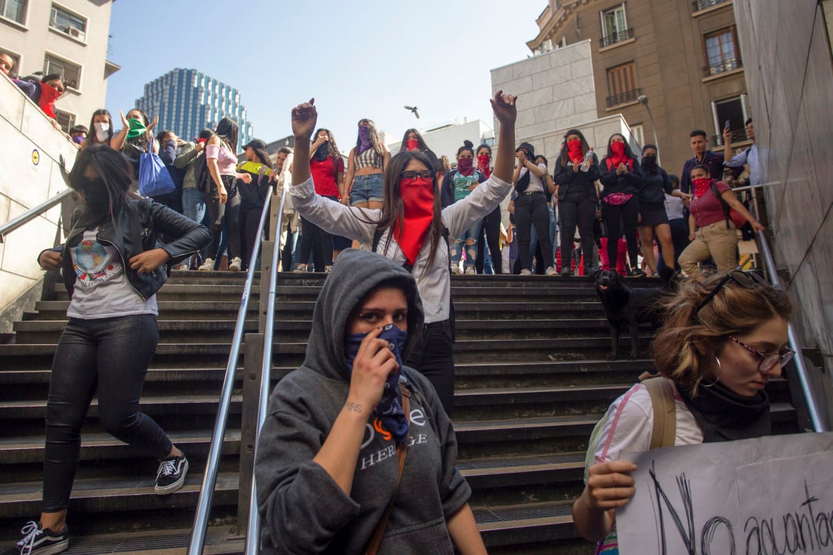 Students demonstrate at the entrance of the Bellas Artes metro station during a mass fare-dodging protest in Santiago, Chile, on October 18, 2019.