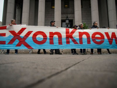 Environmental activists rally outside of New York Supreme Court with a banner reading: Exxon Knew