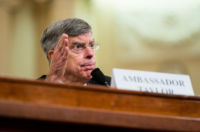 Bill Taylor speaks into a microphone at a hearing