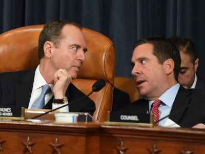 House Intelligence Committee Chair Adam Schiff, left, talks with Rep. Devin Nunes during an impeachment hearing