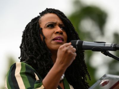 Rep. Ayanna Pressley speaks into a microphone