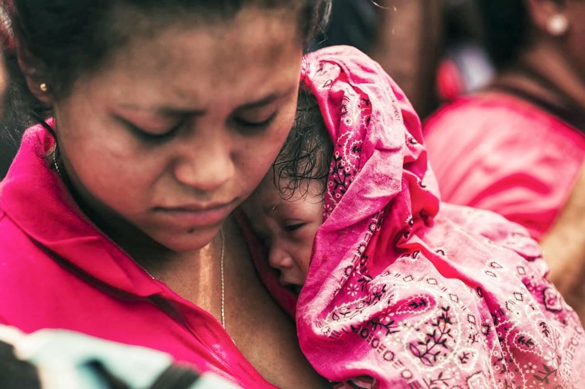 A migrant woman and her baby are detained by Mexican authorities in Tapachula, Mexico, on October 12, 2019.