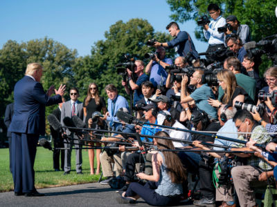 President Trump talks to members of the press on the South Lawn of the White House, July 30, 2019.