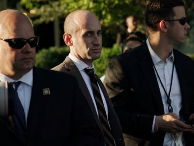 Stephen Miller is flanked by two gaurds
