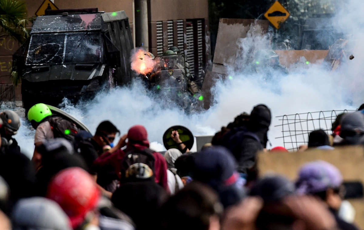 Demonstrators clash with riot police during a protest against the government in Santiago, Chile, on November 18, 2019.