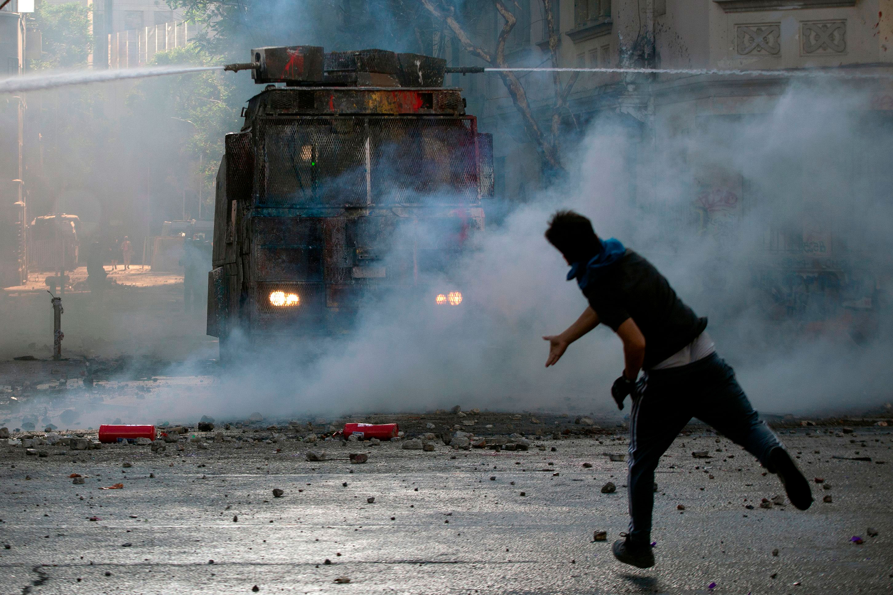 Riot police approach during a protest in Santiago, Chile, on November 22, 2019.