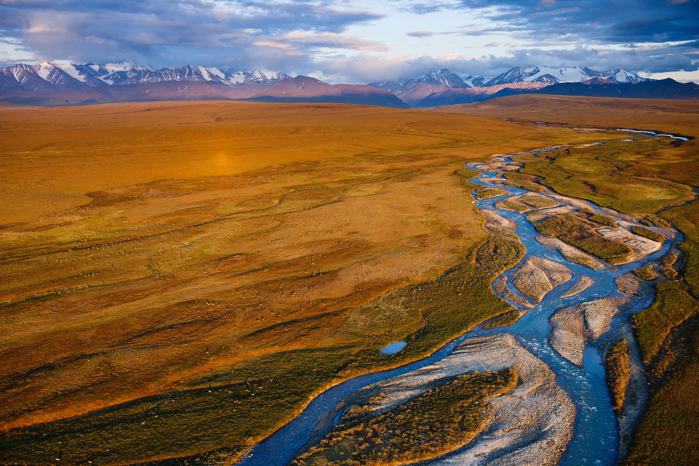 A river stretches through plains in an aerial shot