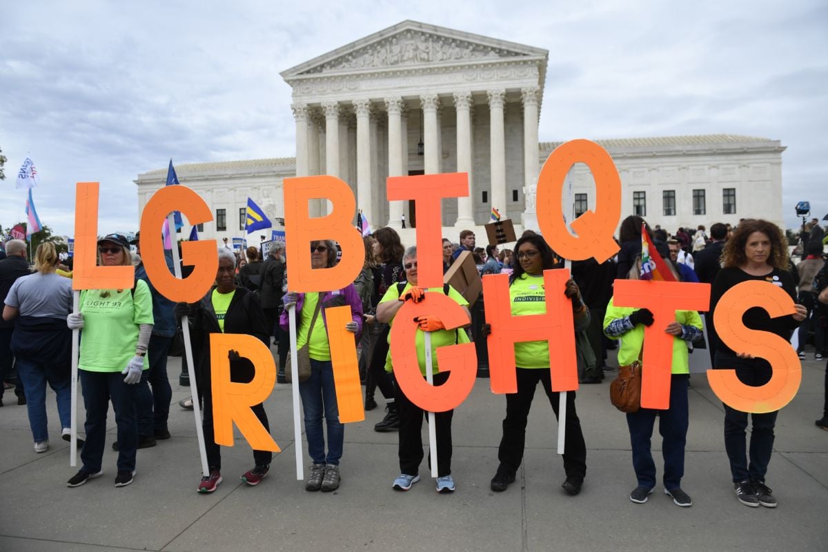 Demonstrators rally outside the US Supreme Court in Washington, DC, October 8, 2019, as the Court holds oral arguments in three cases dealing with workplace discrimination based on sexual orientation.