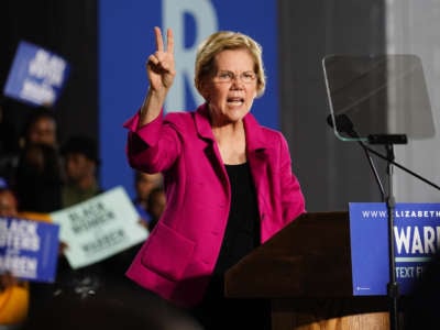 Democratic presidential candidate Sen. Elizabeth Warren (D-MA), holds up two fingers to represent her two-cent wealth tax while speaking at a campaign event at Clark Atlanta University on November 21, 2019, in Atlanta, Georgia.
