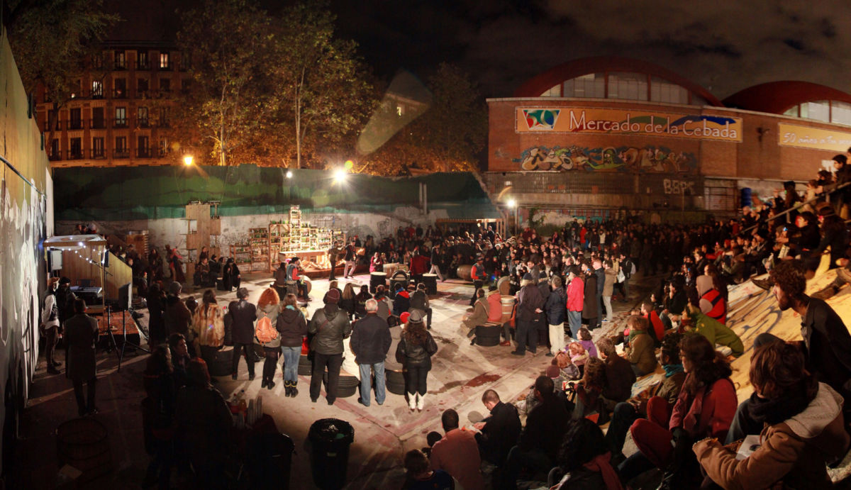 El Campo De Cebada, Madrid hosts a nighttime event with a large audience.