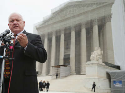 Russel Pearce stands in front of the supreme court building