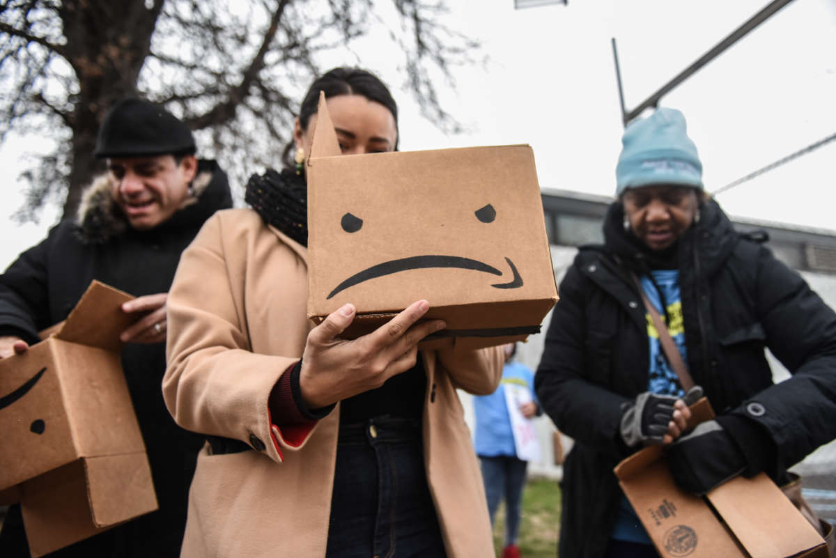 Immigrant and labor activists participate in a rally outside of an Amazon distribution center on December 16, 2019 in the Queens borough of New York City.