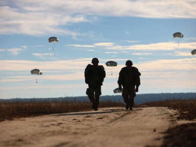 U.S. paratroopers return after completing their jumps at Fort Bragg, North Carolina, December 4, 2015.