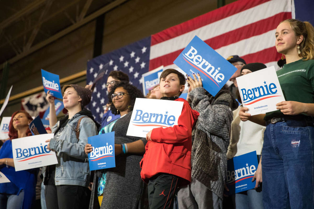 Supporters of Sen. Bernie Sanders hold up signs during his event at Nashua Community College on December 13, 2019, in Nashua, New Hampshire.