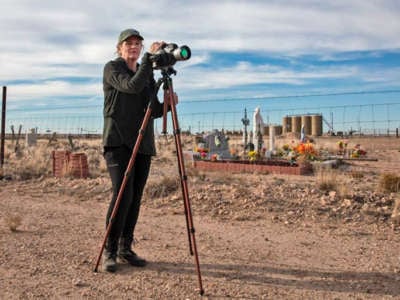 Sharon Wilson with an optical gas imaging camera next to the Lara Cemetery near a Diamond Back oil and gas production site outside of Pecos, Texas.