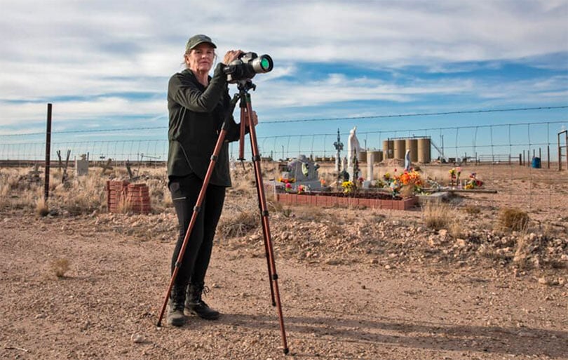 Sharon Wilson with an optical gas imaging camera next to the Lara Cemetery near a Diamond Back oil and gas production site outside of Pecos, Texas.