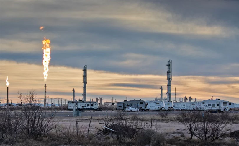 Flares at Eagle Claw Midstream Pecos Bend Gas Plant next to what is known as a “man camp” where the primarily male workers live in temporary housing.