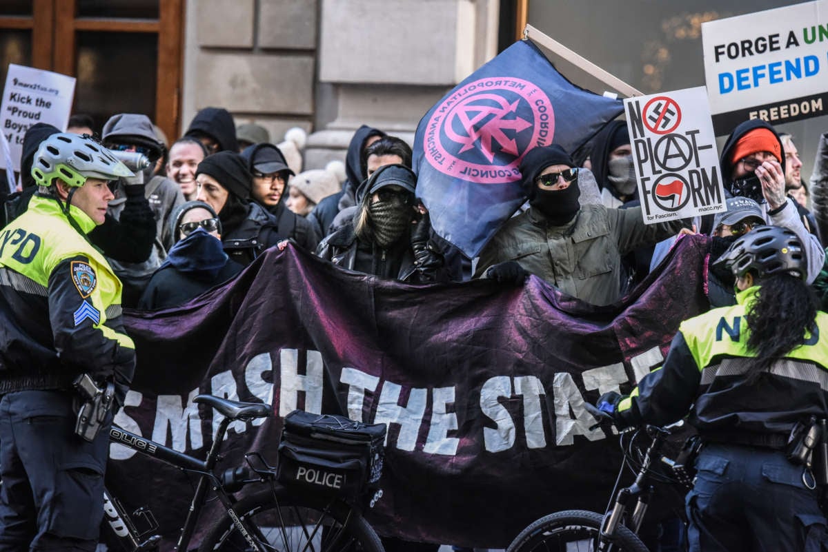 Anti-fascists display signs during a protest