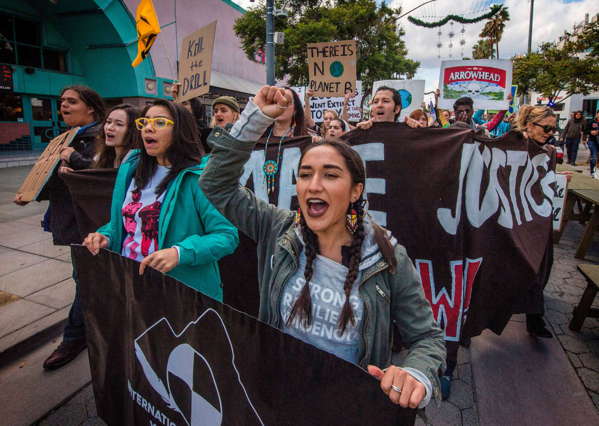Students and their supporters protest as they demand transformative climate action during the Black Friday sales in Santa Monica, California, on November 29, 2019.