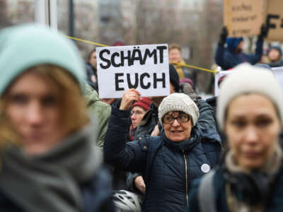 One day after the election of Thuringia's State Premier, a protester holds a placard reading "Shame on you" during a demonstration in front of the State Chancellery in Erfurt, eastern Germany, on February 6, 2020.