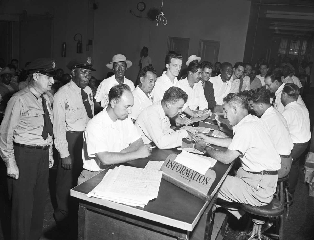 A crowd of veterans wait their turn to get counsel on schooling on the last day to file papers under the G.I. bill in New York, July 25, 1951.
