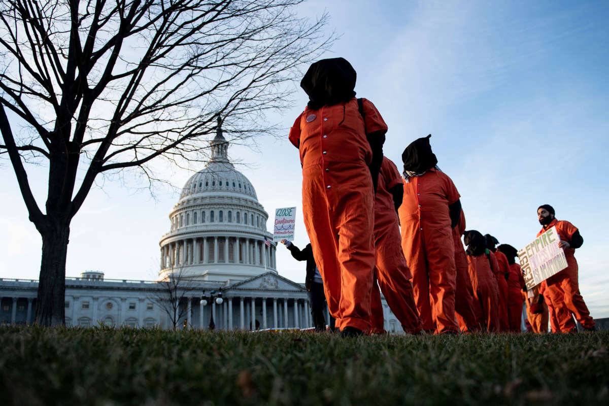 Demonstrators dressed in Guantanamo Bay prisoner uniforms march past Capitol Hill in Washington, D.C, on January 9, 2020, during a rally against war with Iran.