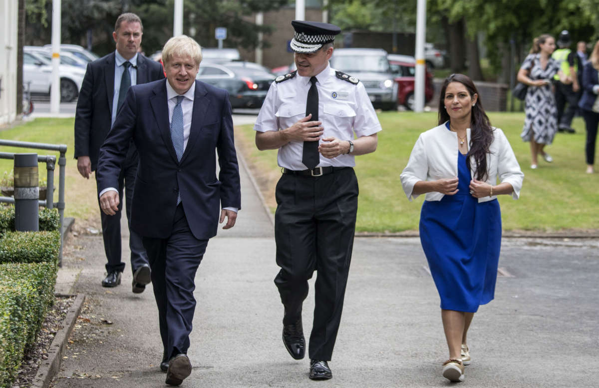 Britain's Prime Minister Boris Johnson, Chief Constable Dave Thompso and Home Secretary Priti Patel arrive to meet graduates of West Midlands Police training centre in Birmingham, central England on July 26, 2019.