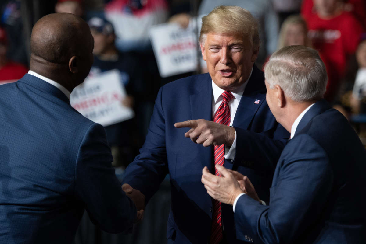 Donald Trump, Sen. Tim Scott and Sen. Lindsey Graham attend a Keep America Great campaign rally at the North Charleston Coliseum in North Charleston, South Carolina, February 28, 2020.