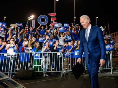 Joe Biden walks by a crowd of supporters