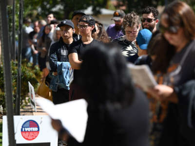 Voters wait in a long line to cast their ballot in the presidential primary at the Buena Vista Branch Library in Burbank, California, on Super Tuesday, March 3, 2020.