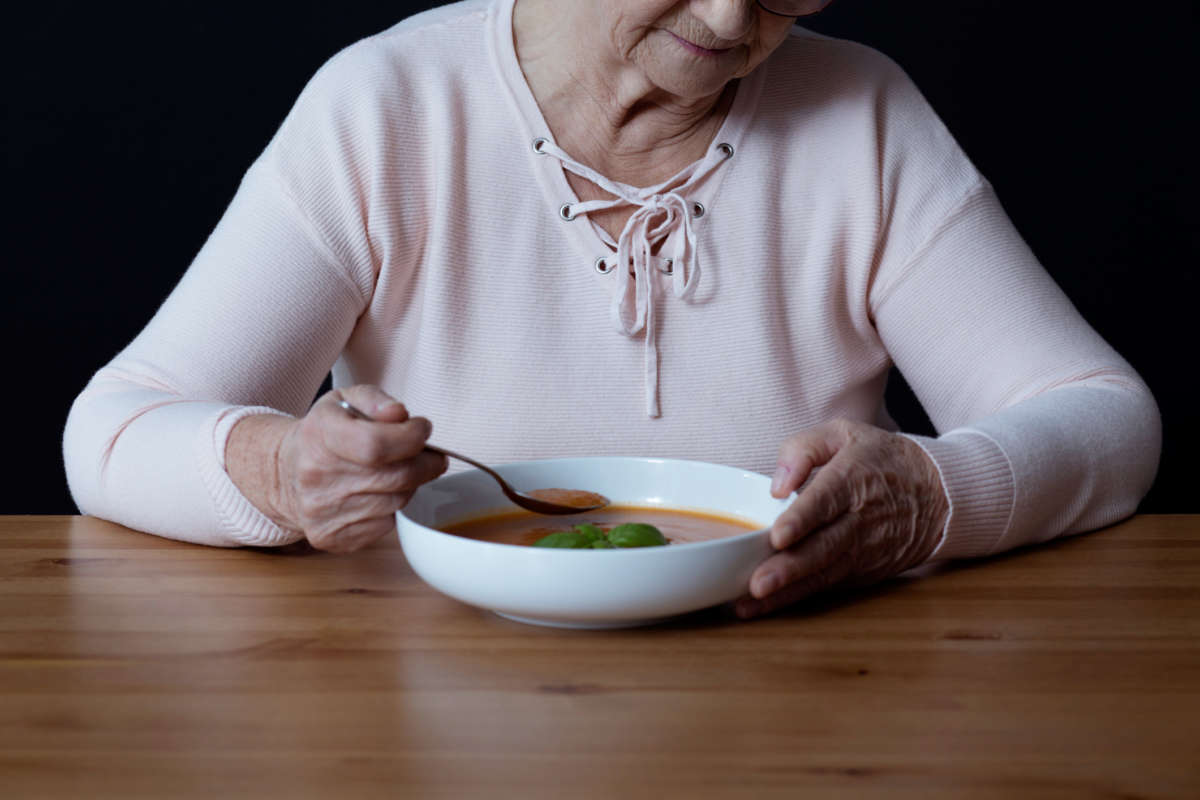 A grandma spoons up some soup
