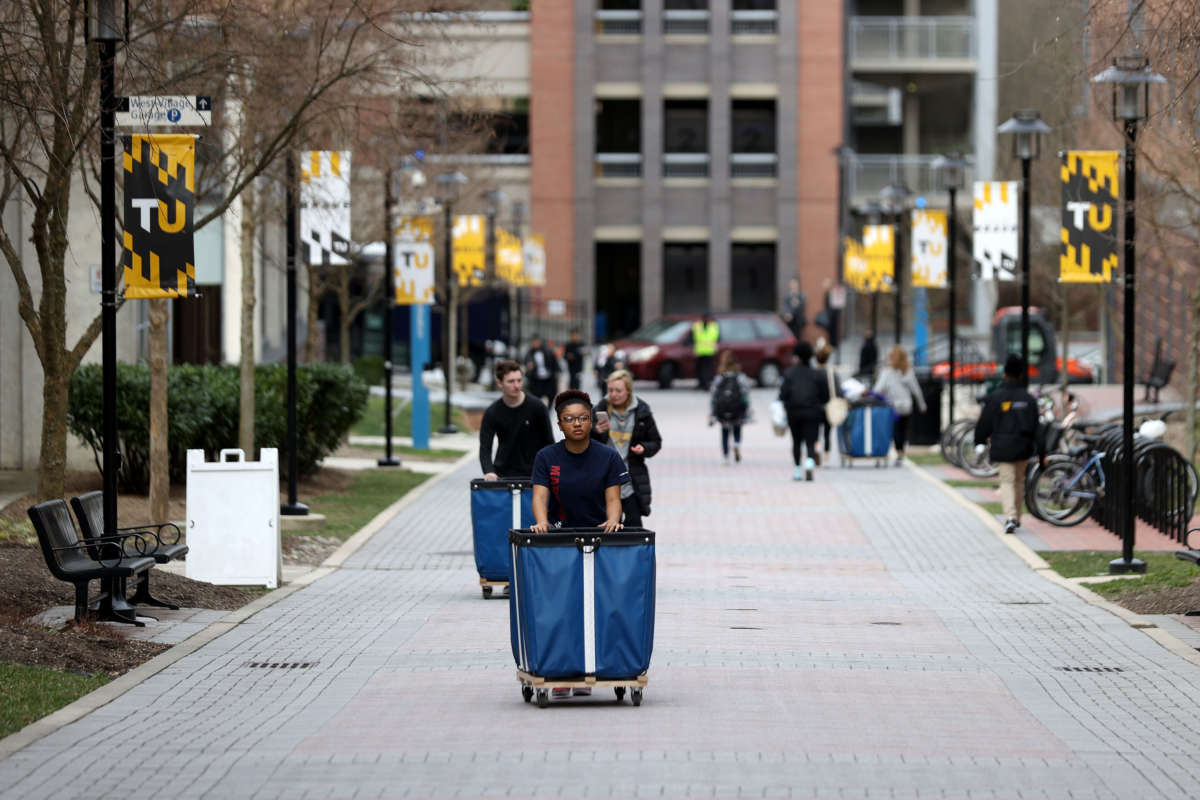Towson University students remove their belongings from the dorms as the school shuts down days before the start of the scheduled spring break on March 11, 2020, in Towson, Maryland.