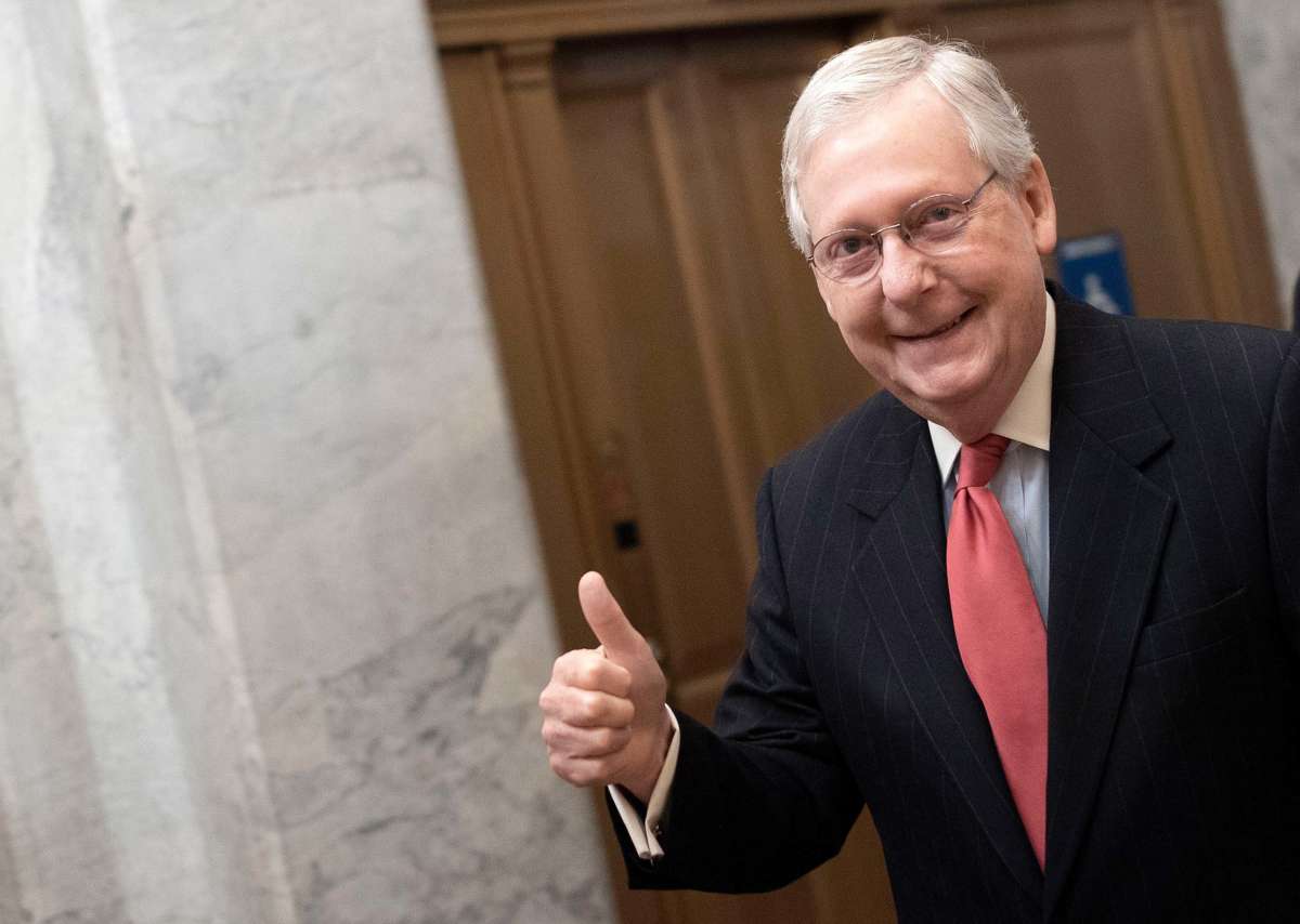 Senate Majority Leader Mitch McConnell gives a thumbs up sign as he arrives at the U.S. Capitol on March 25, 2020, in Washington, D.C.
