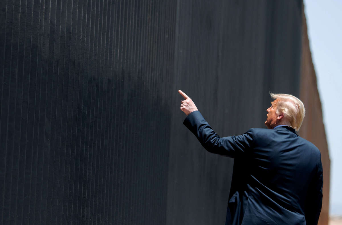 President Trump gestures toward fencing at the international border with Mexico in San Luis, Arizona, June 23, 2020.
