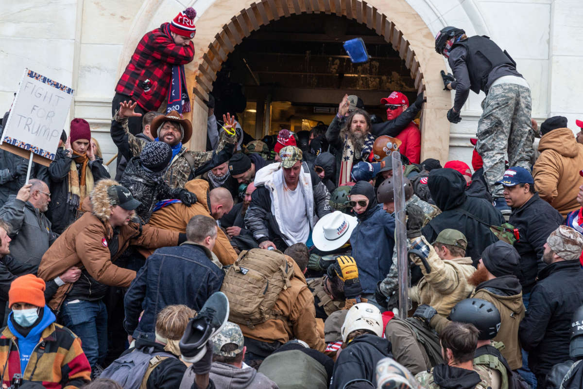 Trump loyalists clash with police trying to enter Capitol building through the front doors. Rioters broke windows and breached the Capitol building in an attempt to overthrow the results of the 2020 election.